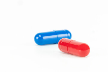 Red and blue pill representing a critical choice or dilemma. A medical and business metaphor for...