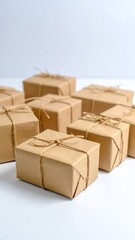 Fototapeta premium Group Of Wrapped Brown Paper Gifts Tied With Biodegradable Twine On White Background