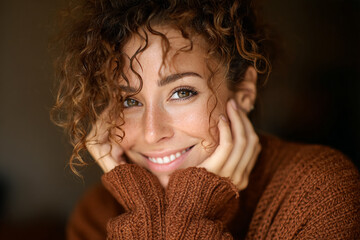 Woman smiles. Girl poses in brown sweater. Headshot. Portrait. Design, marketing, web use.