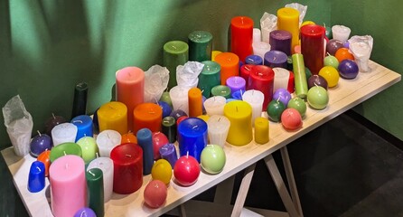 Lots of colorful aromatic candles - a collection of different colors and shapes