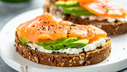 Delicious sandwiches with smoked salmon and avocado on multigrain bread with cream cheese.