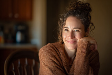 Woman in Sweater Smiles at Camera. Concept: Wellbeing, Portrait.