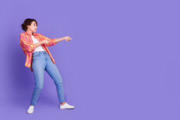 Full length profile portrait of nice young lady pull empty space wear shirt isolated on purple...
