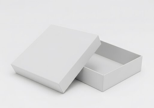 A slightly open white box with a lid resting beside it on a white surface in a studio setting view