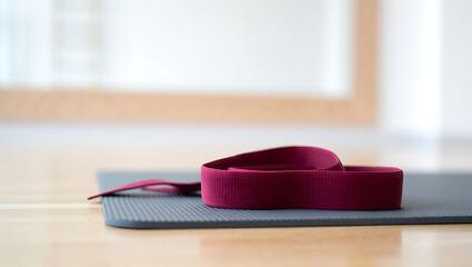 Yoga mat and strap on studio floor