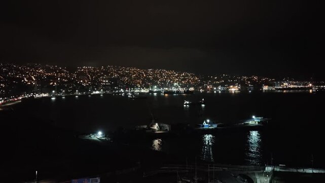 Valpara&iacute;so at night, panoramic view with bright avenues, hills, and port.