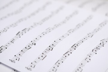 Fototapeta premium Sheets with musical notes as background, closeup