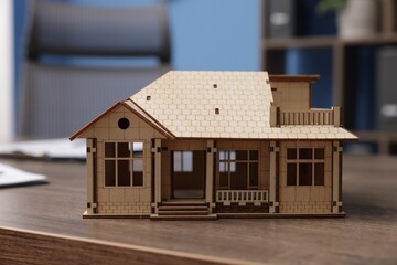House model on desk in real estate agent's office, closeup