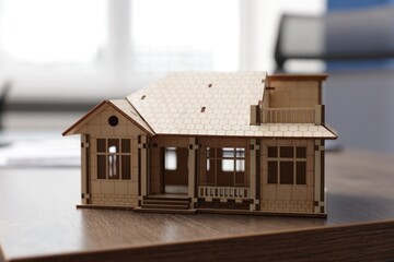 House model on desk in real estate agent's office, closeup