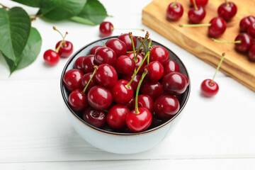 Fresh ripe cherries on white wooden table, closeup