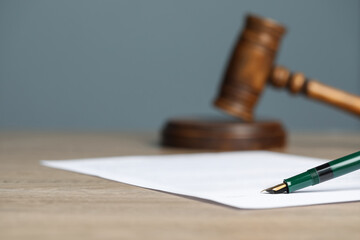 Notary document and fountain pen on wooden table against grey background, selective focus. Space...