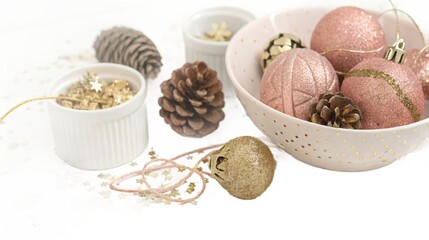 Sparkling rose gold christmas ornaments and pinecones with gold stars