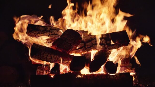 Big Bonfire Burns in the Dark Flaming Campfire at Nighttime. Video with sound.