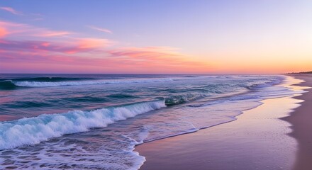 Fototapeta premium Vibrant Pink and Purple Sunset Over Ocean Waves and Sandy Beach Shoreline