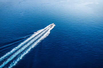 Aerial view of a luxury yacht sailing over the blue, mediterranean sea in Greece, with copy space