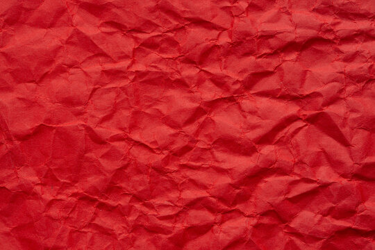 Macro red crumpled paper background,Red crumpled paper background, close up. Red sandy paper texture. Red wrapping paper as Christmas background.