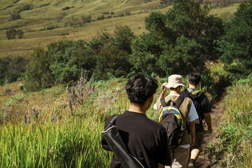 Three Southeast Asian men hiking on the Mount Bromo trail