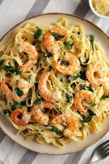 Homemade Creamy One-Pot Spinach Shrimp Pasta on a Plate, top view.