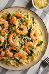 Homemade Creamy One-Pot Spinach Shrimp Pasta on a Plate, top view.