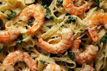 Homemade Creamy One-Pot Spinach Shrimp Pasta on a Plate, top view. Close-up.