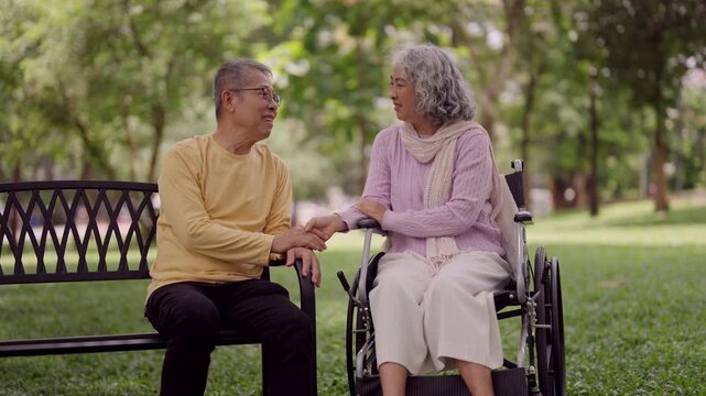Asian older couple sharing intimate conversation outdoor park setting mutual support retirement wellbeing connection