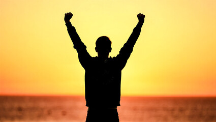 Fototapeta premium Minimalist figure with arms raised in victory against a simple sunrise, symbolizing triumph and motivation.