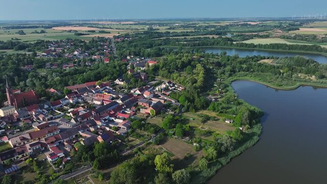 Aerial view of Penkun, Uckermark, where red-roofed houses meet the tranquil lake waters, a blend of rural charm and natural beauty, Penkun, Brandenburg, Germany.