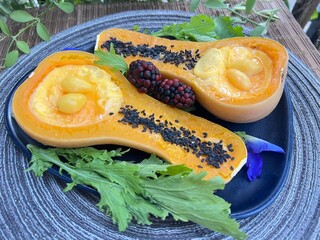 Butternut squash bowl filled with savory steamed egg custard on top with black sesame