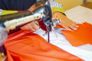 The process of cutting cloth to sew the red and white flag, Indonesia's national flag. The theme is celebrating independence on August 17, 1945.