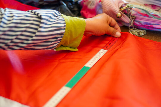 The measurement process for creating the red and white flag, Indonesia's national flag. The theme is celebrating independence on August 17, 1945.
