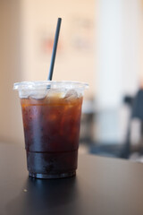 Closeup of take away plastic cup of iced black coffee Americano