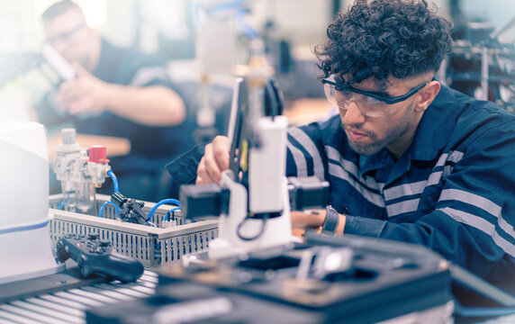 Mechanical engineering team working in robotic technology lap for research and develop for manufacturing automation and robotics.