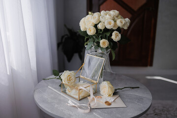 Elegant floral arrangement and decorative box on a table in a light-filled room