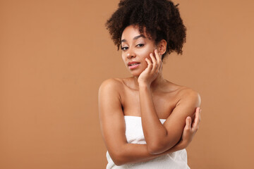 Portrait of beautiful Brazilian woman after spa treatment on light brown background. Space for text