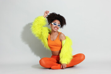 Fashionable portrait of beautiful Brazilian woman in stylish outfit on white background