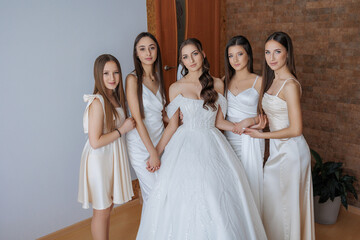 Naklejka premium Group of young women dressed elegantly celebrating together in a bright modern room