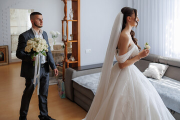 Couple prepares for wedding ceremony in elegant indoor setting
