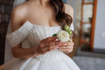 Bridal preparation with elegant bouquet and gown indoors before wedding ceremony