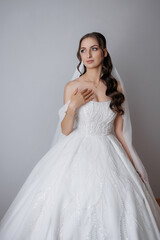 Elegant bride in a stunning white gown preparing for her wedding ceremony indoors