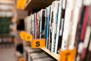 Books, audiobooks, radio dramas, and films on a shelf in a library. School readings. School and university library