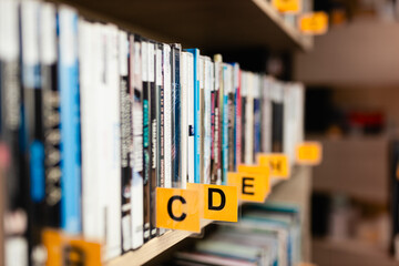 Books, audiobooks, radio dramas, and films on a shelf in a library. School readings. School and university library