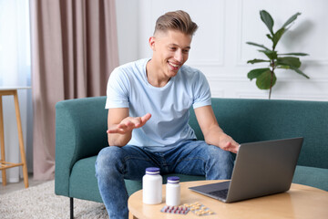 Man showing thumbs up while having online consultation with doctor via laptop at home