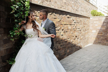 Couple shares a romantic moment during their wedding day in a beautiful outdoor setting
