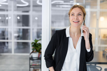 Confident young business woman having a call and looking involved and contented