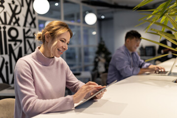 Blonde cute young woman in coworking area feeling good during work