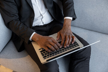 Confident businessman working on a laptop and looking involved