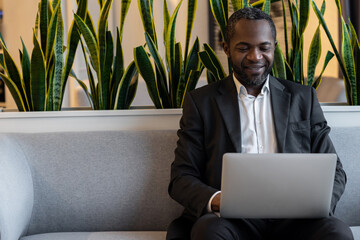 African american businessman having a video call and lookin contented