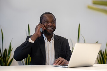 Businessman having a phone call and smiling positively