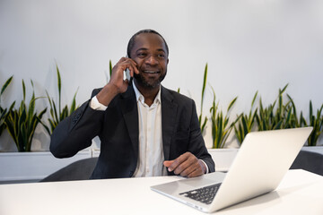 Businessman having a phone call and feeling excited and positive