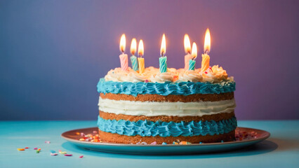 Decorated birthday cake in blue tones with fondant look, pastel candles, perfect for celebrations